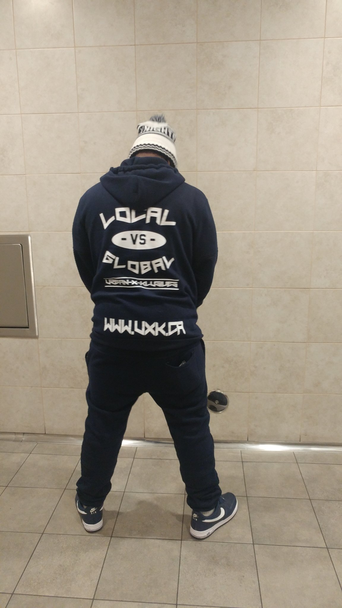 Back of the UXK hoodie reading Local vs Global, UXK.CA