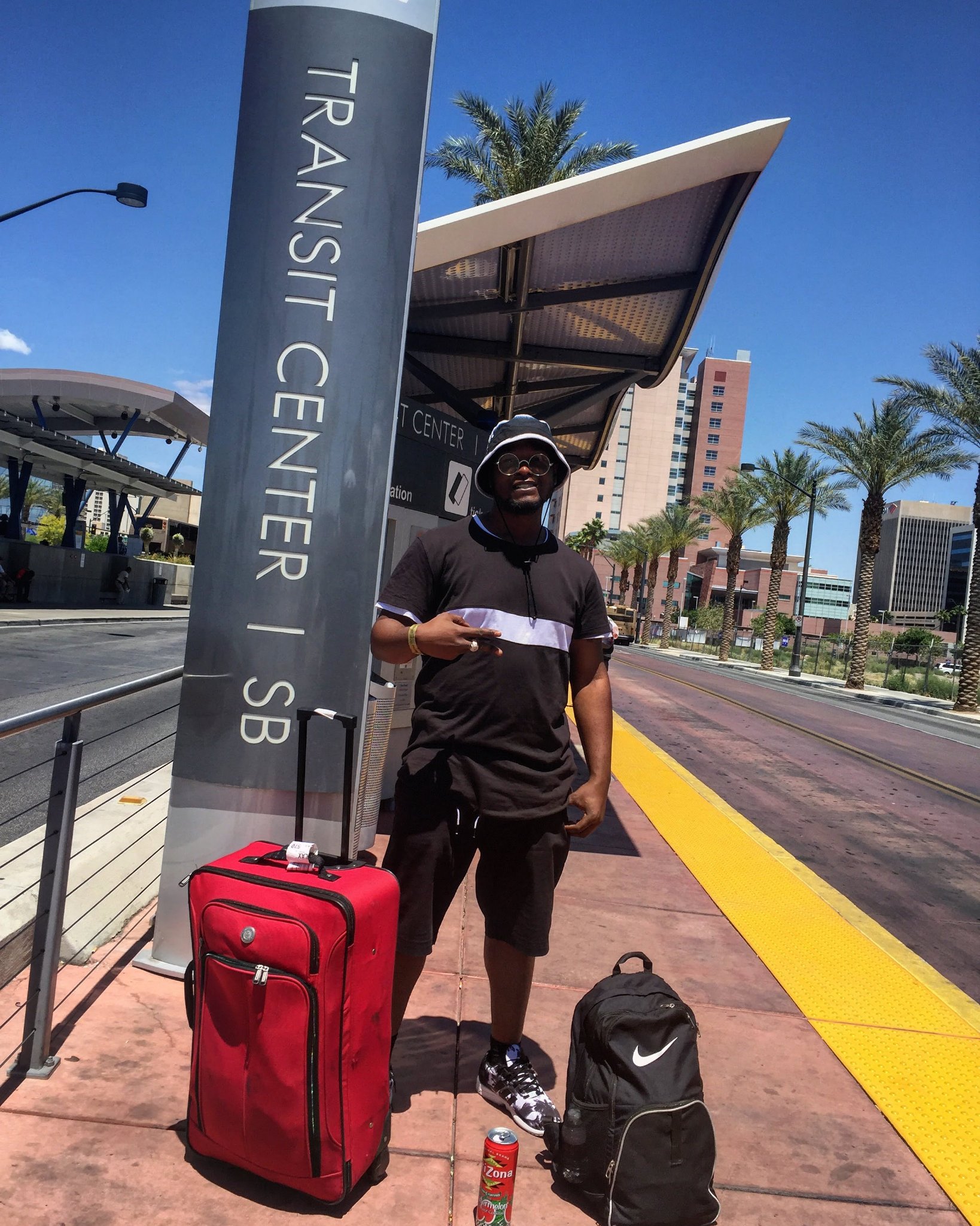 Trav at a transit center in Las Vegas with his luggage