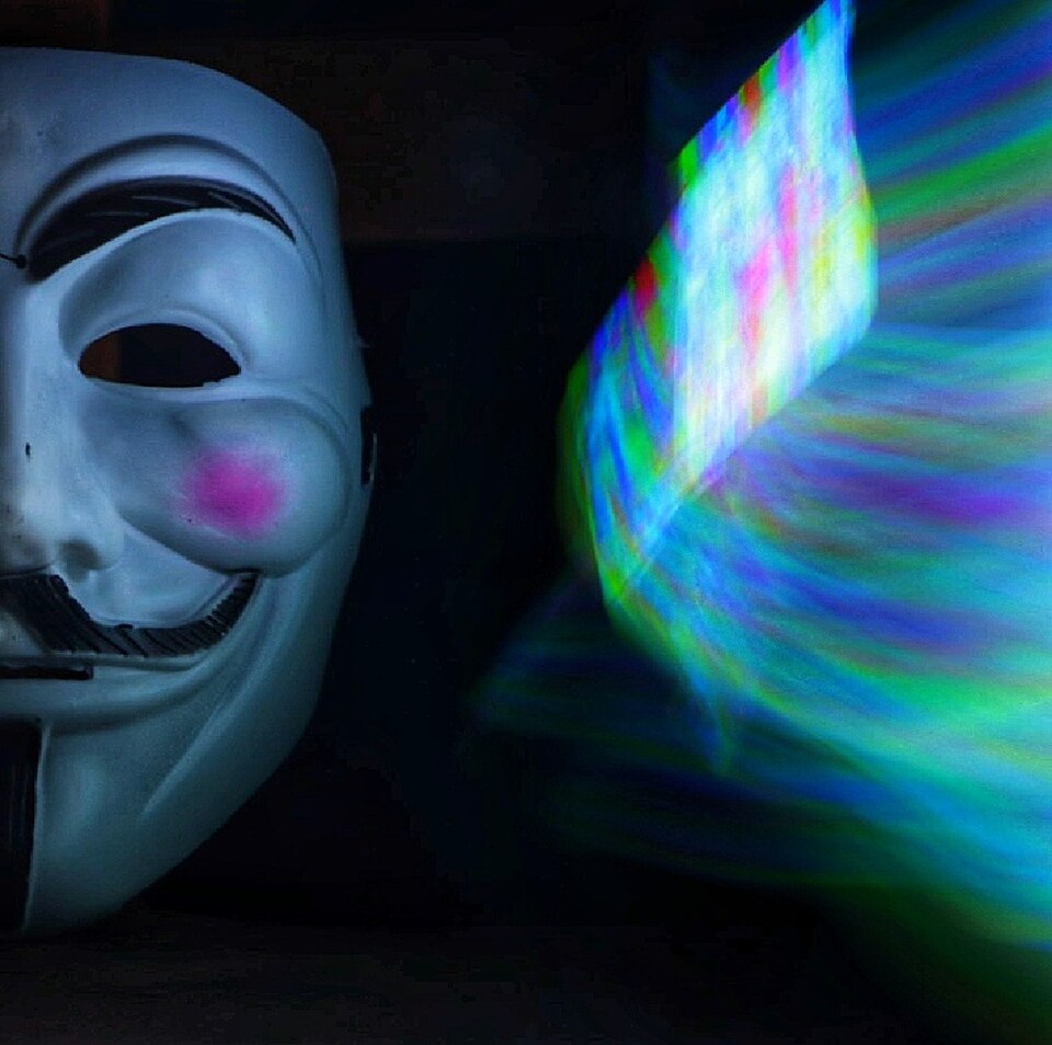 Masked figure before a glowing screen — topical image for the @UrbanXklusives account hijack story